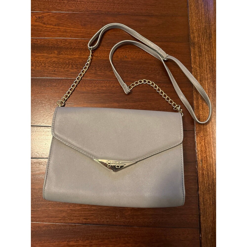 Jessica Simpson envelope crossbody bag featuring a chain strap and gold-tone